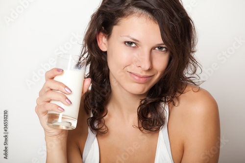 young woman holding glass of milk