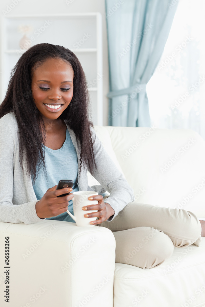 Woman on sofa texting Woman on sofa texting