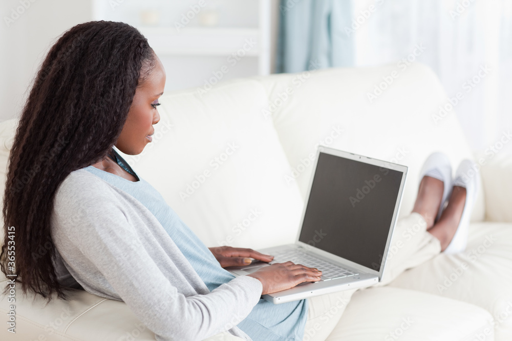 Woman on sofa surfing the internet