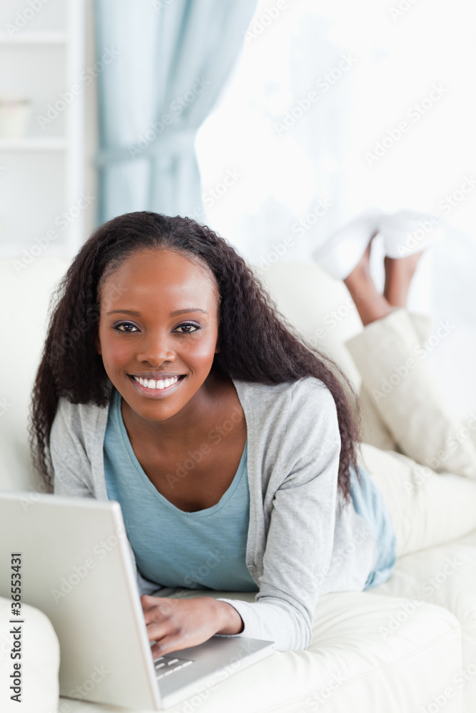 Close up of woman on couch surfing the internet Close up of woman on couch surfing the internet
