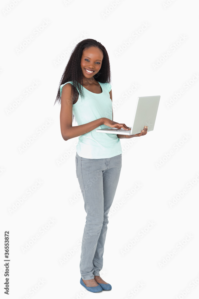 Woman typing on her laptop on white background Woman typing on her laptop on white background