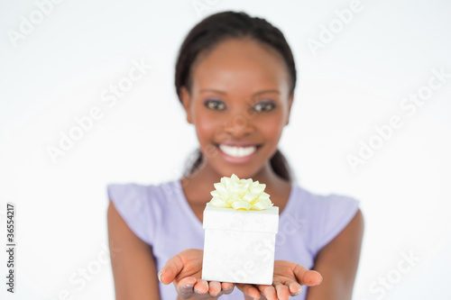 Close up of present being held by woman against a white backgrou