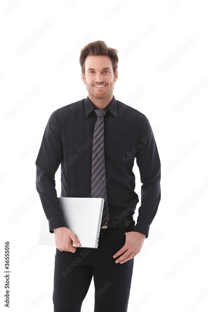 Young businessman holding laptop smiling Young businessman holding laptop smiling