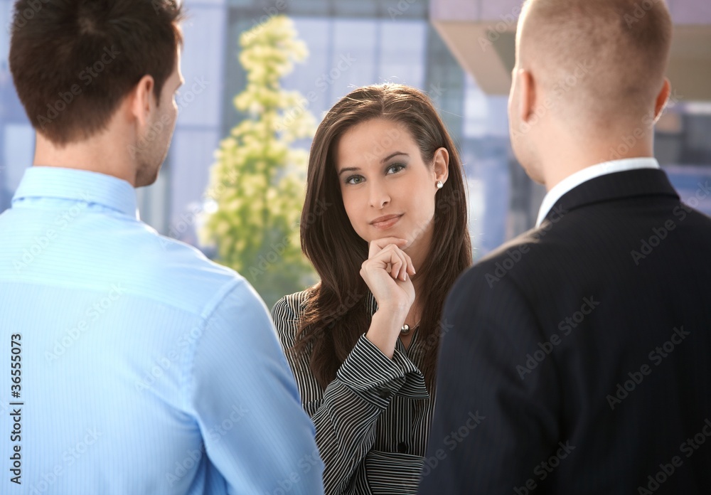 Businesswoman listening to colleagues