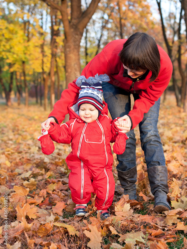 happy young mother with her son outdoor in the autumn park