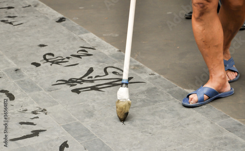 man doing chinese calligraphy