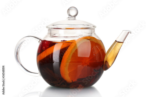 Glass teapot with black tea and orange isolated on white