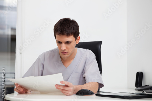 Doctor reading reports