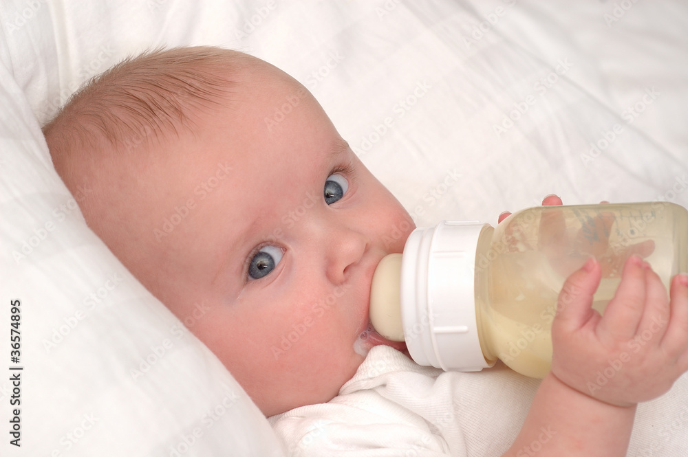 Six month old baby boy drinking his bottle Six month old baby boy drinking his bottle