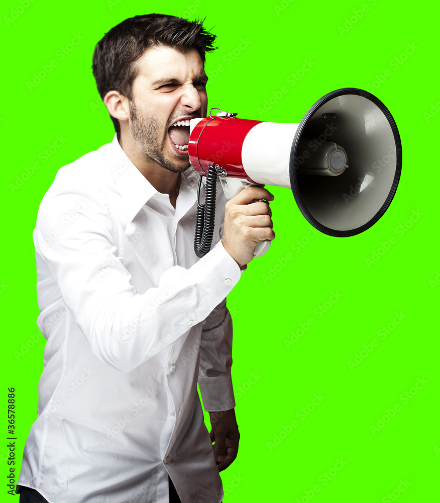 man shouting with megaphone over removable chroma key background man shouting with megaphone over removable chroma key background