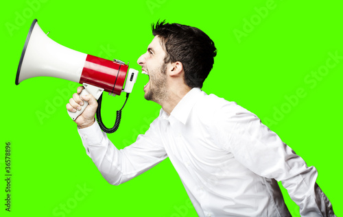 man shouting with megaphone over removable chroma key background