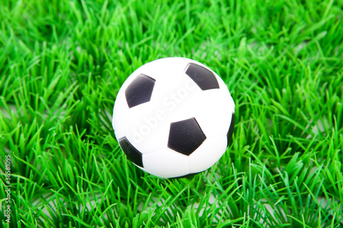 One soccer ball on plastic grass
