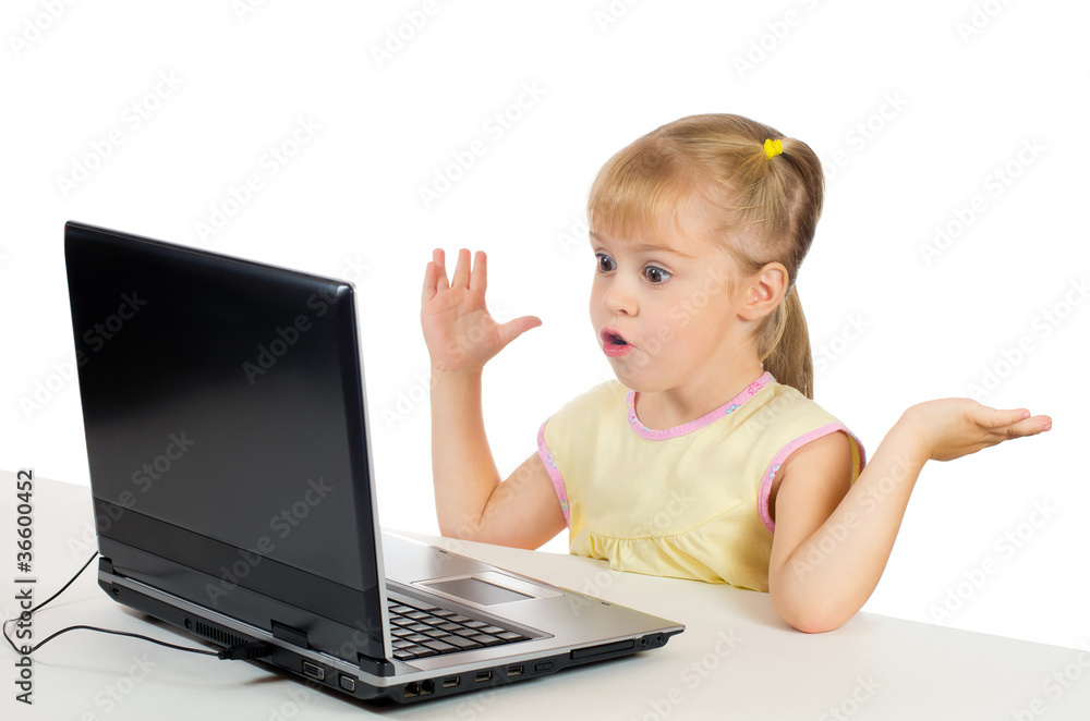 Little girl with a surprised face is on the computer Little girl with a surprised face is on the computer
