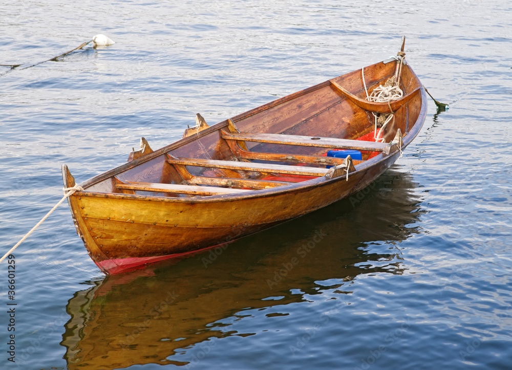 The wooden rowing and sailing boat