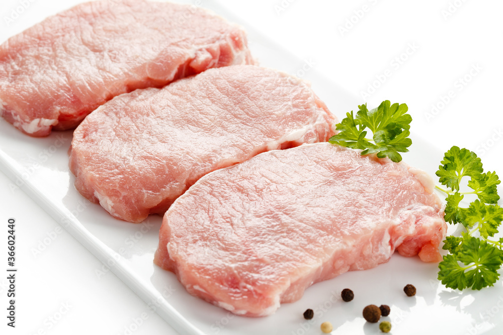 Fresh raw pork on white plate