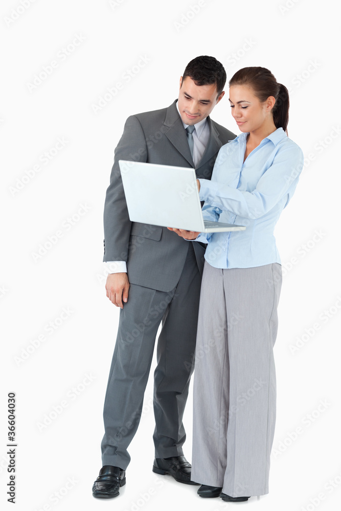 Business partner looking at a notebook against a white backgroun Business partner looking at a notebook against a white backgroun