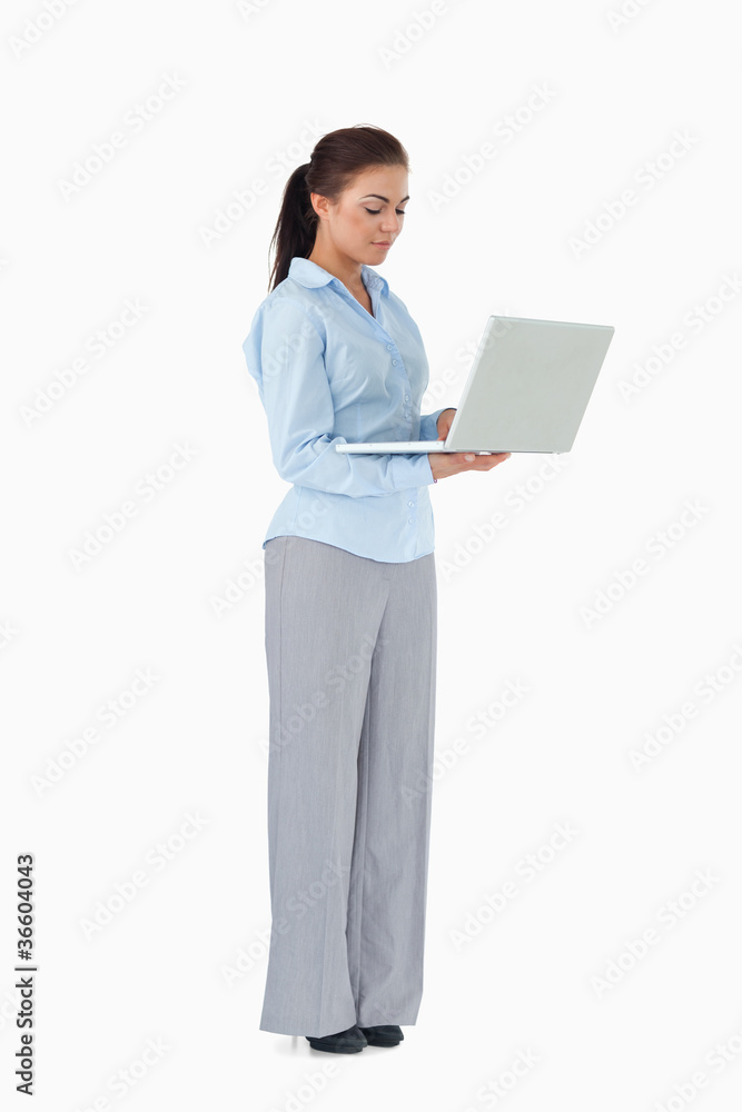 Professional woman working on laptop against a white background Professional woman working on laptop against a white background