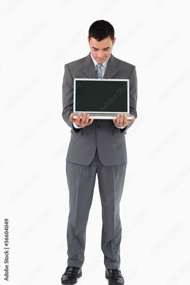 Businessman standing with his laptop against a white background Businessman standing with his laptop against a white background
