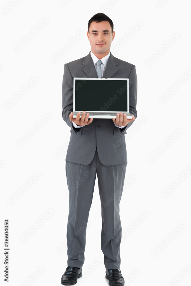 Confident businessman presenting his notebook against a white ba Confident businessman presenting his notebook against a white ba