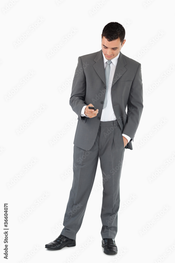Businessman writing textmessage against a white background Businessman writing textmessage against a white background