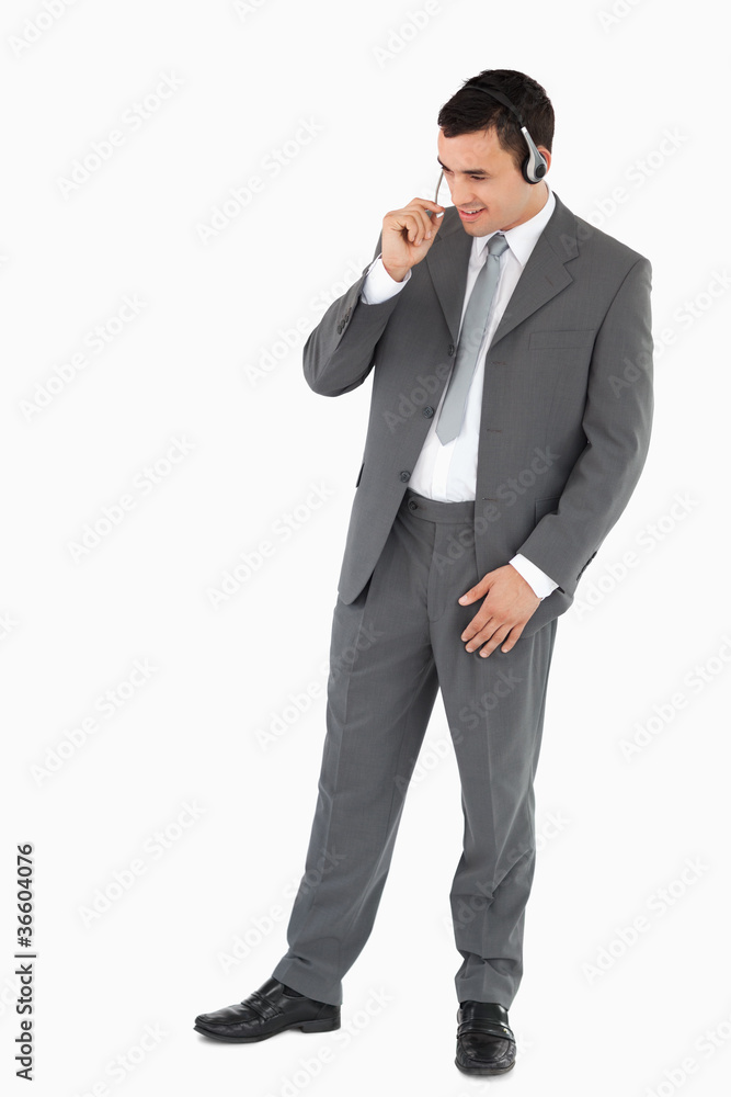 Businessman with headset against a white background Businessman with headset against a white background