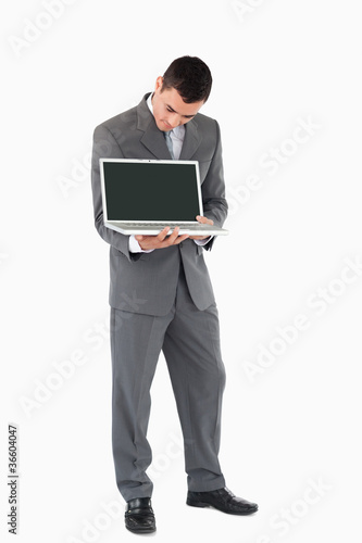 Businessman showing whats on his screen against a white backgrou
