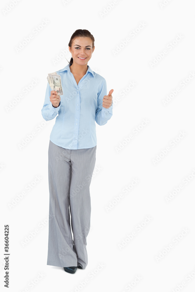 Smiling businesswoman with banknotes giving thumb up Smiling businesswoman with banknotes giving thumb up
