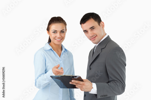 Smiling business partners with clipboard
