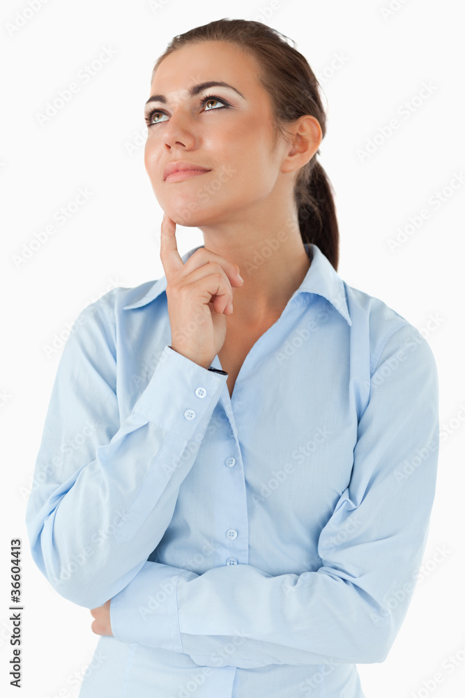 Thinking businesswoman looking diagonally upwards Thinking businesswoman looking diagonally upwards