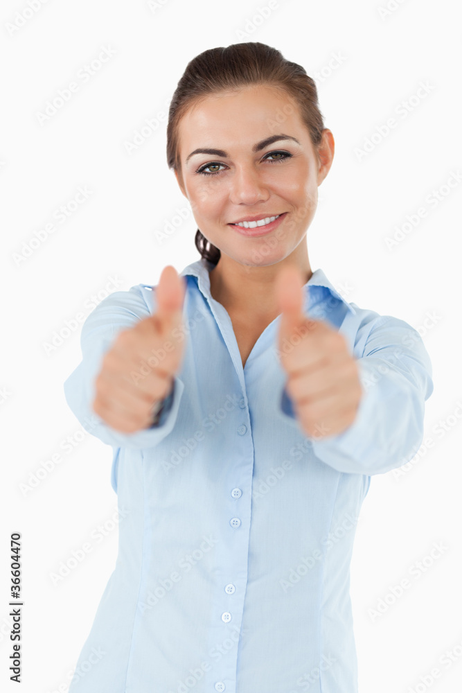 Smiling businesswoman giving both thumbs up Smiling businesswoman giving both thumbs up