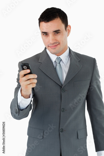 Confident businessman with his cellphone
