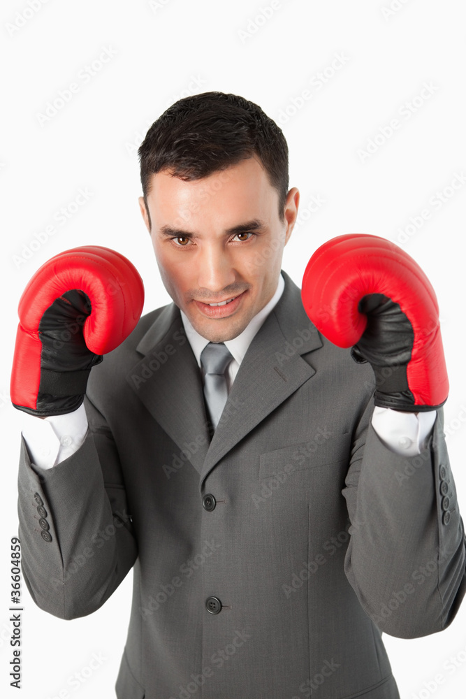 Close up of smiling businessman with boxing gloves on Close up of smiling businessman with boxing gloves on
