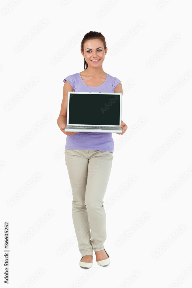 Smiling young female presenting her laptop screen Smiling young female presenting her laptop screen