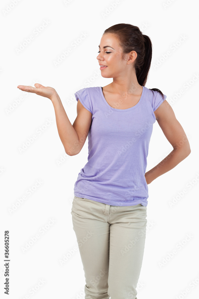 Young female looking at what she is presenting Young female looking at what she is presenting