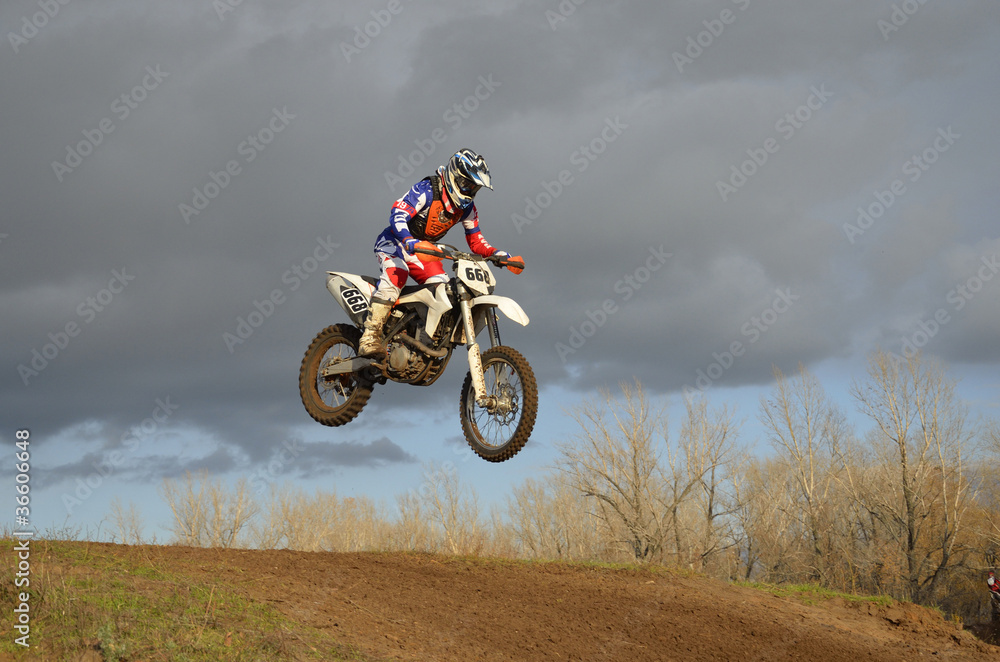 A leap over the hill, motorcycle racer on a motorbike