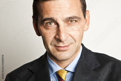 Portrait of confident businessman over white background