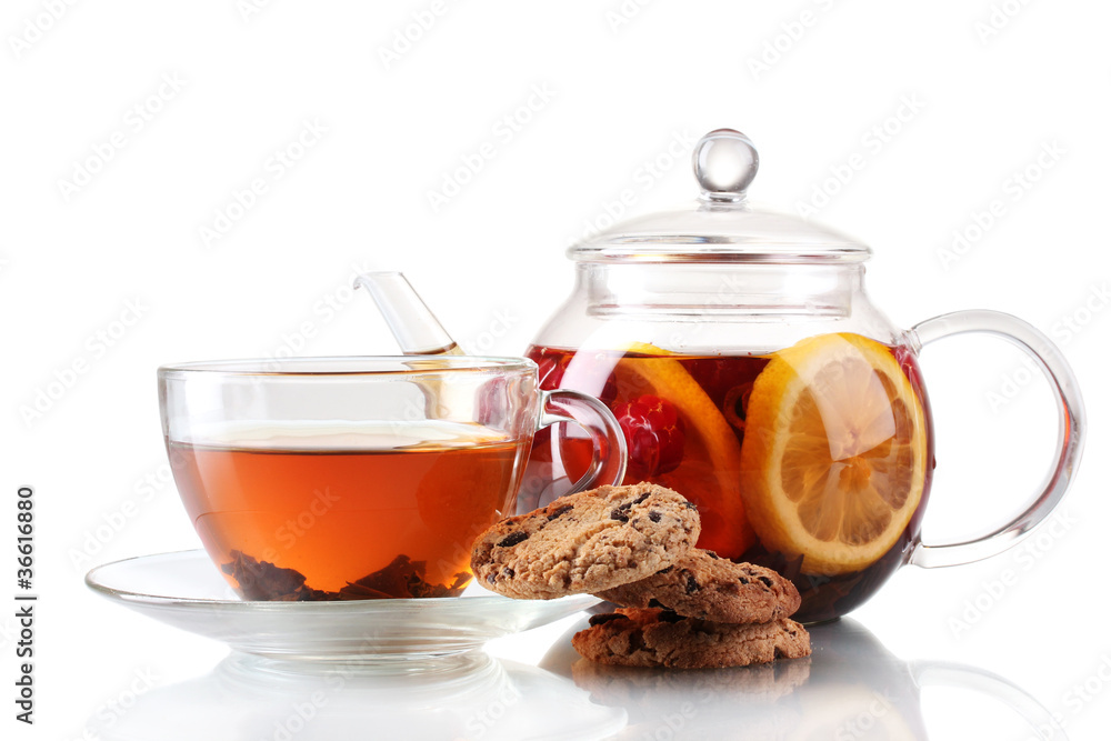 Black fruit tea in glass teaopot and cup isolated on white Black fruit tea in glass teaopot and cup isolated on white