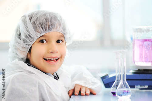 Smart cute little male child experimenting with test tubes