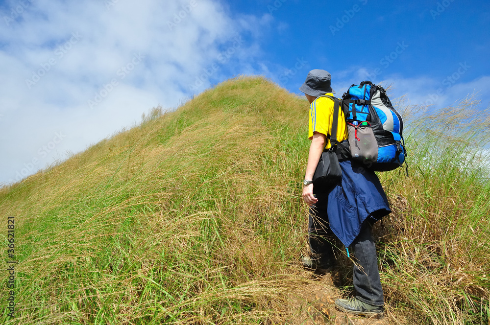 a man keep walking ahead across the mountain