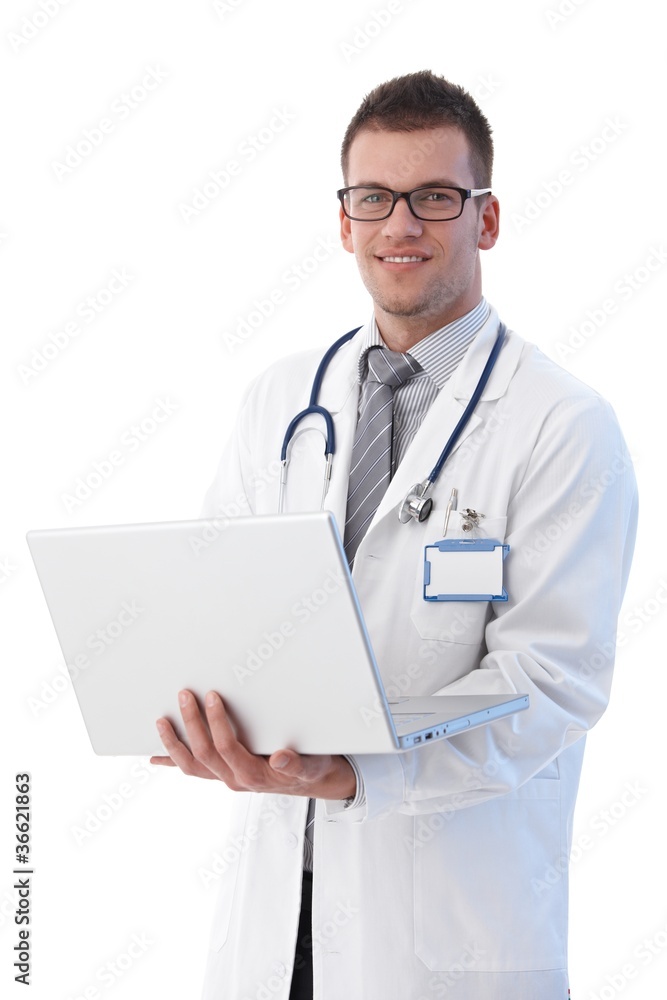 Cheerful young doctor with laptop smiling
