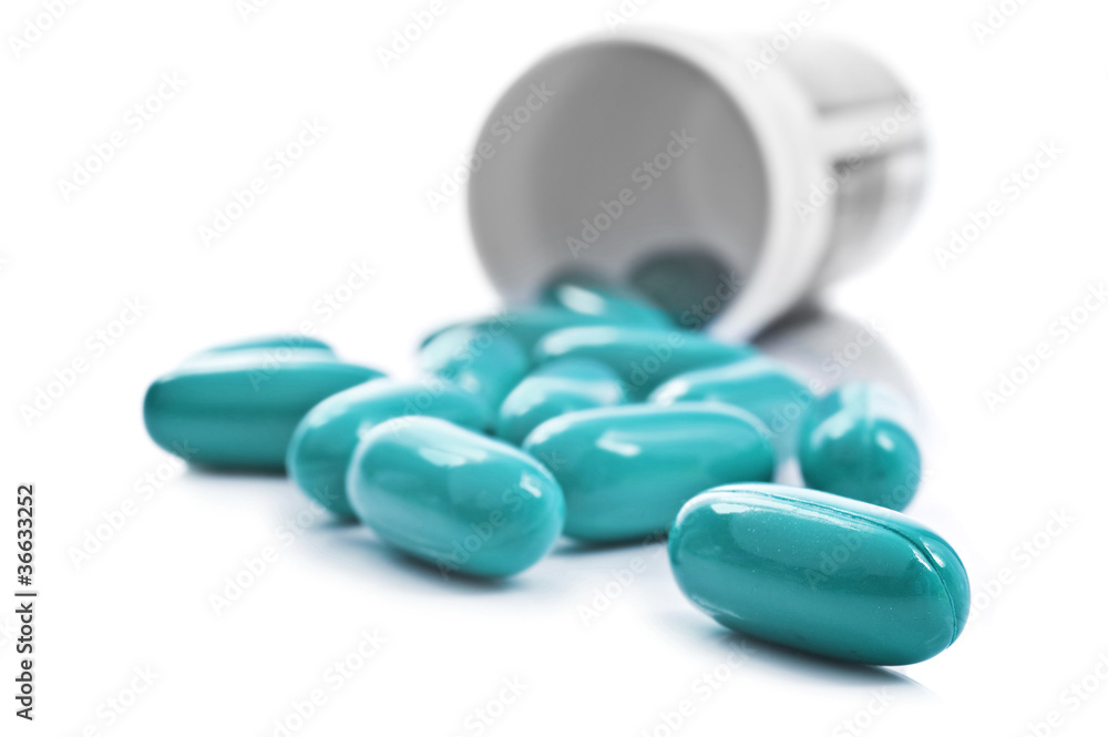 Blue pills an pill bottle on white background Blue pills an pill bottle on white background