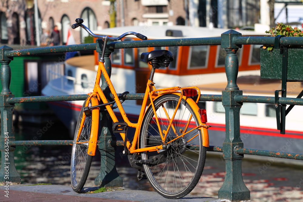 Typical Amsterdam old bike over bridge in Holland.