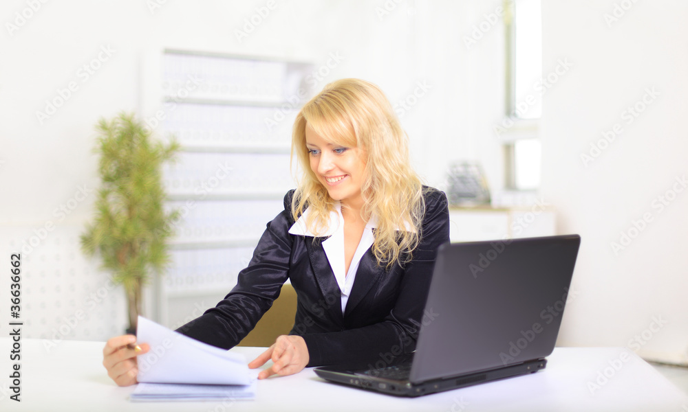 young business woman using laptop at work in an office young business woman using laptop at work in an office