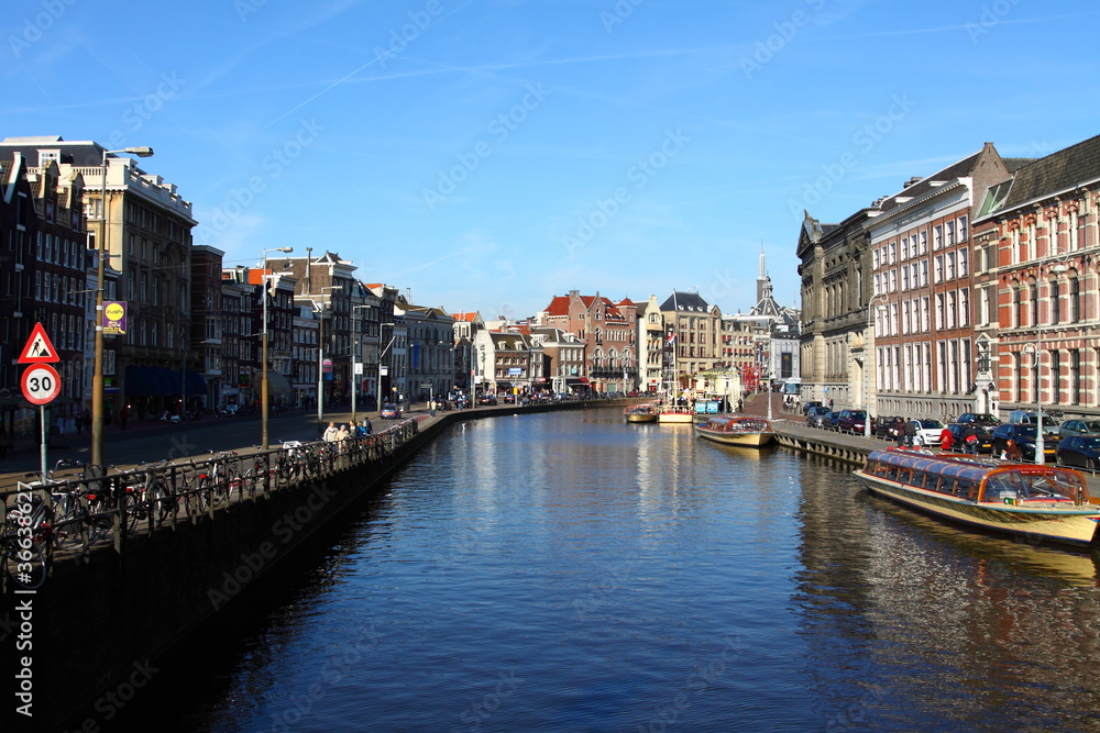 Typical Amsterdam houses over blue sky