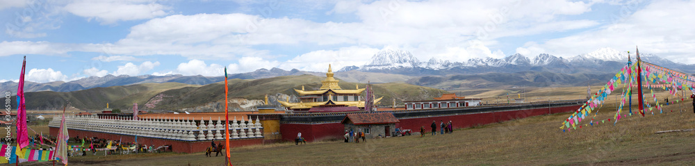 Golden temple with snow mountain panorama