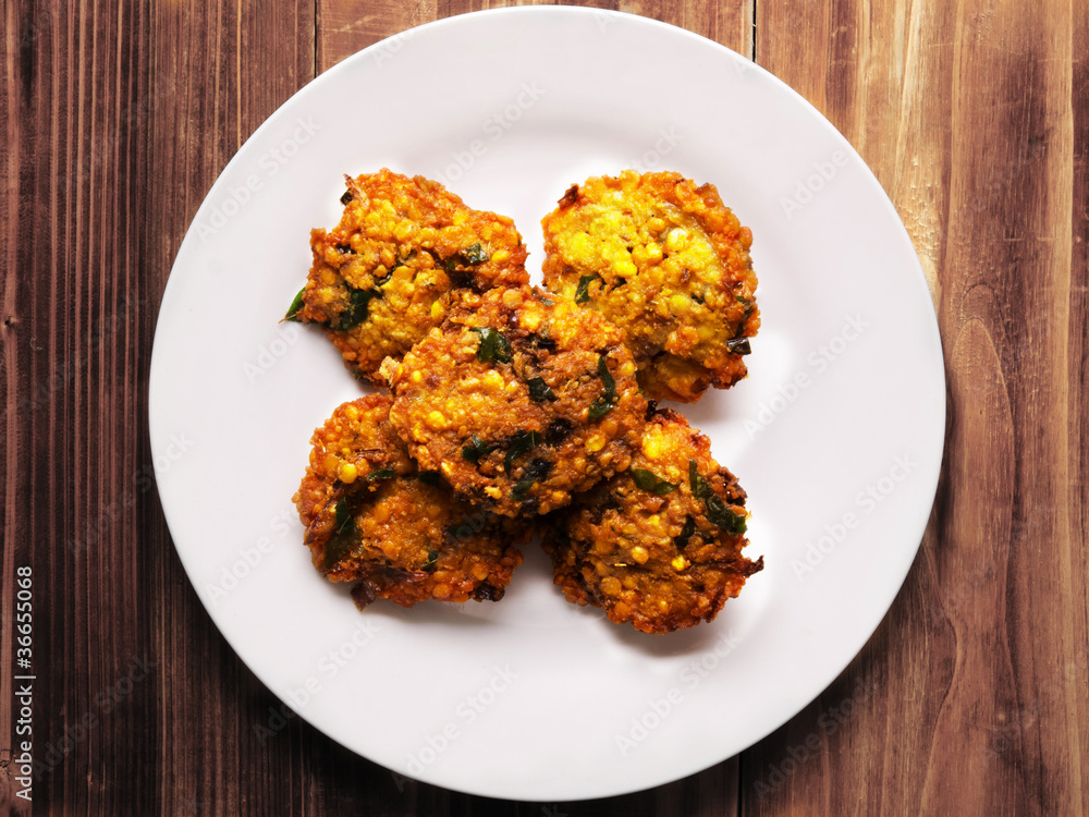 close up of a plate of masala vada close up of a plate of masala vada