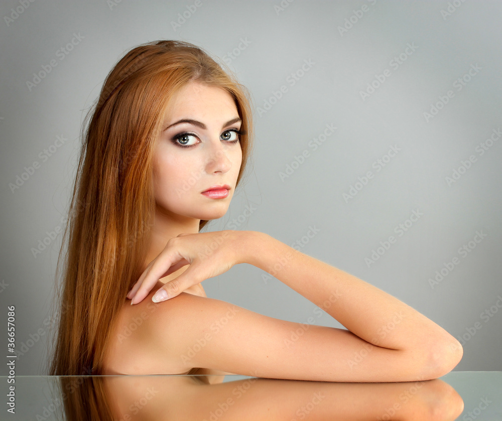 Beautiful young girl on gray background Beautiful young girl on gray background