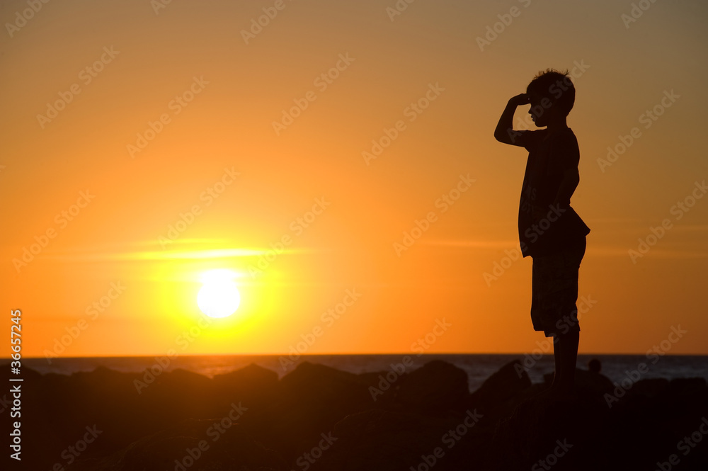 Young boy enjoying sunset