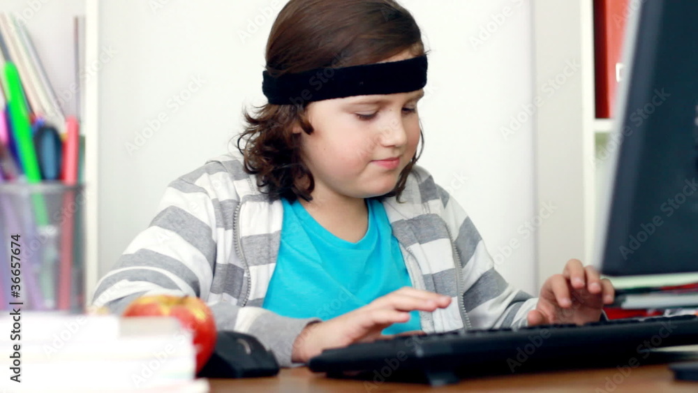 Young happy teenager working on computer at home