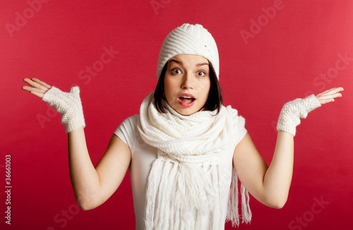 Amazed christmas girl. Isolated on red background.
